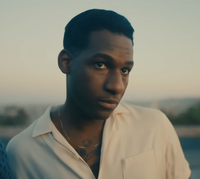 Leon Bridges, one of the celebrities who visited ordinary people, looking thoughtful in a white collared shirt