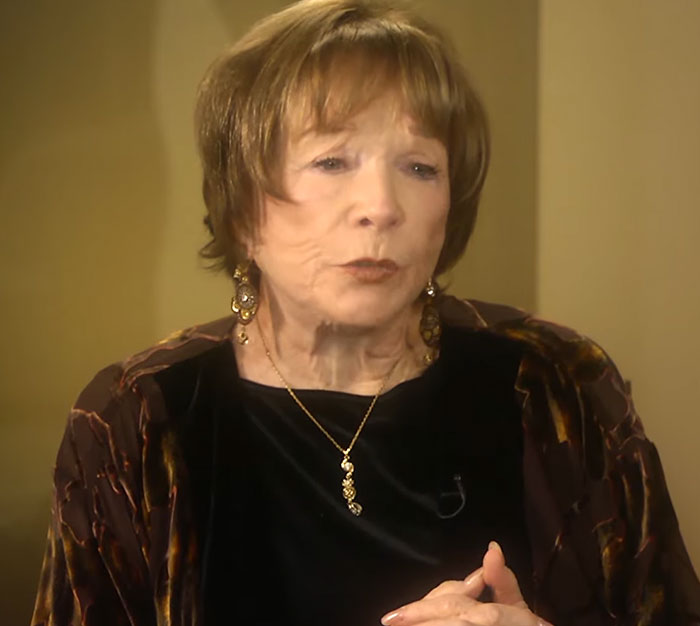 Close-up of an elderly woman speaking, sharing stories of when celebrities visited