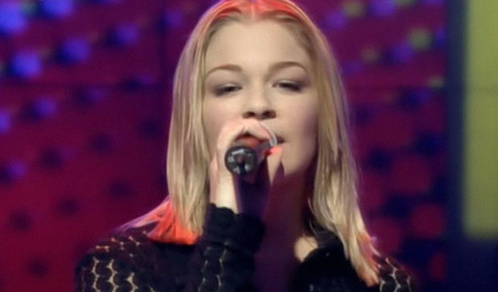 Singer LeAnn Rimes, one of the well known celebrities, performing with a microphone