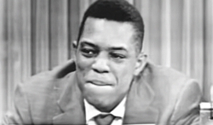 Vintage black and white shot of a man smiling, a memory of celebrities