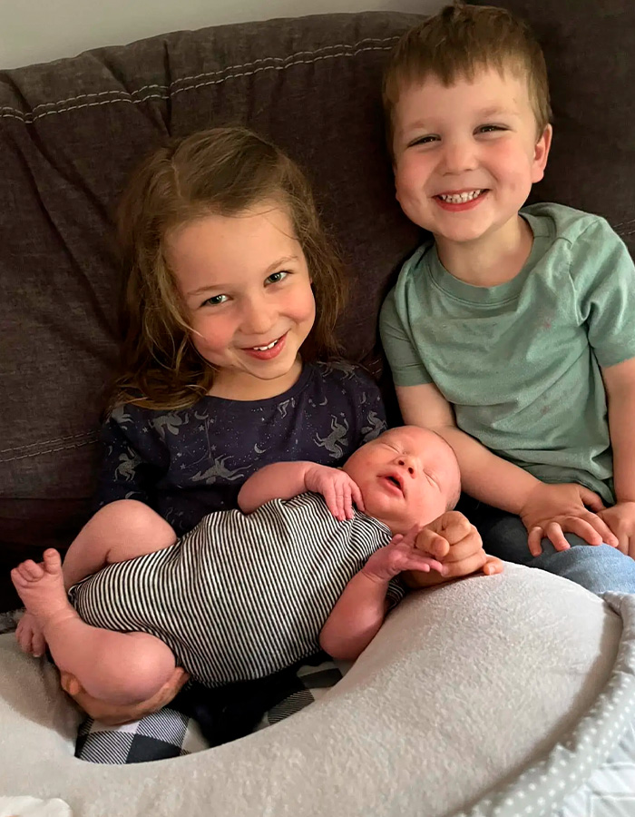 Three smiling children sitting on couch, linked to Patrick Clancy deleted Reddit history Three smiling children sitting on couch, linked to Patrick Clancy deleted Reddit history