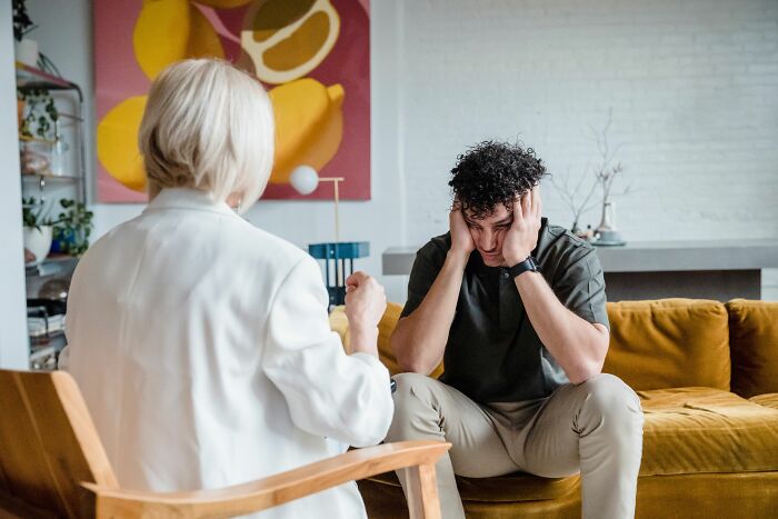 A man talking to a therapist, feeling uneasy, his 6th sense indicating something is off.