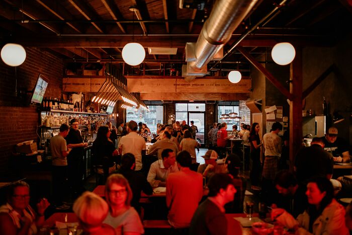 A dimly lit restaurant full of people. The sixth sense of a customer smells a rat.