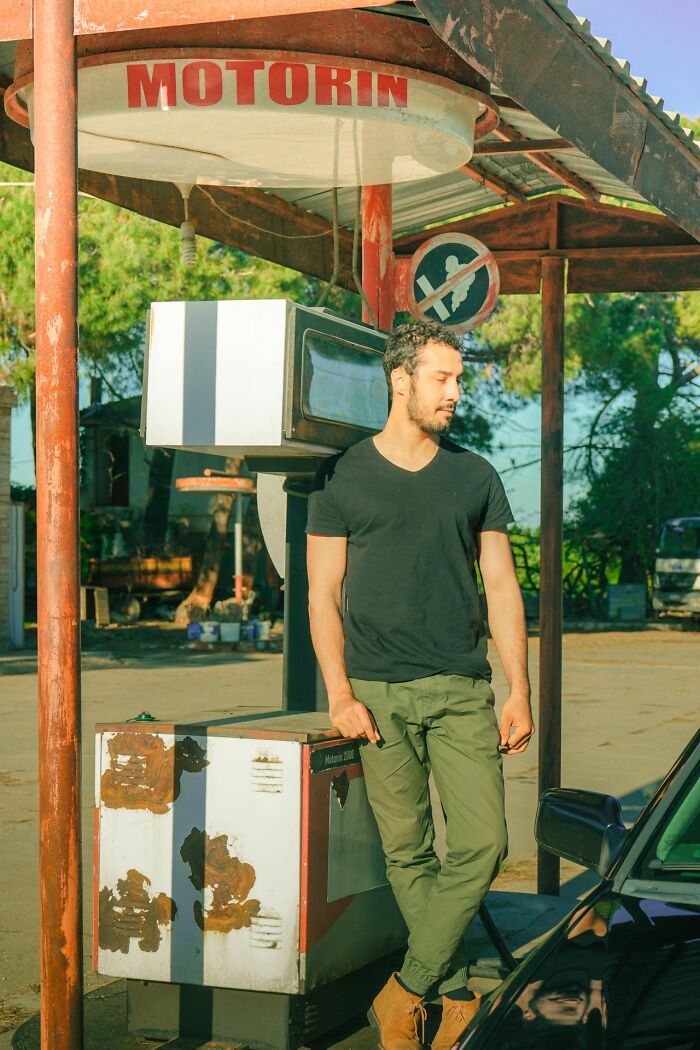 A man leans against an old gas pump, reflecting the feelings when relationships fell apart.