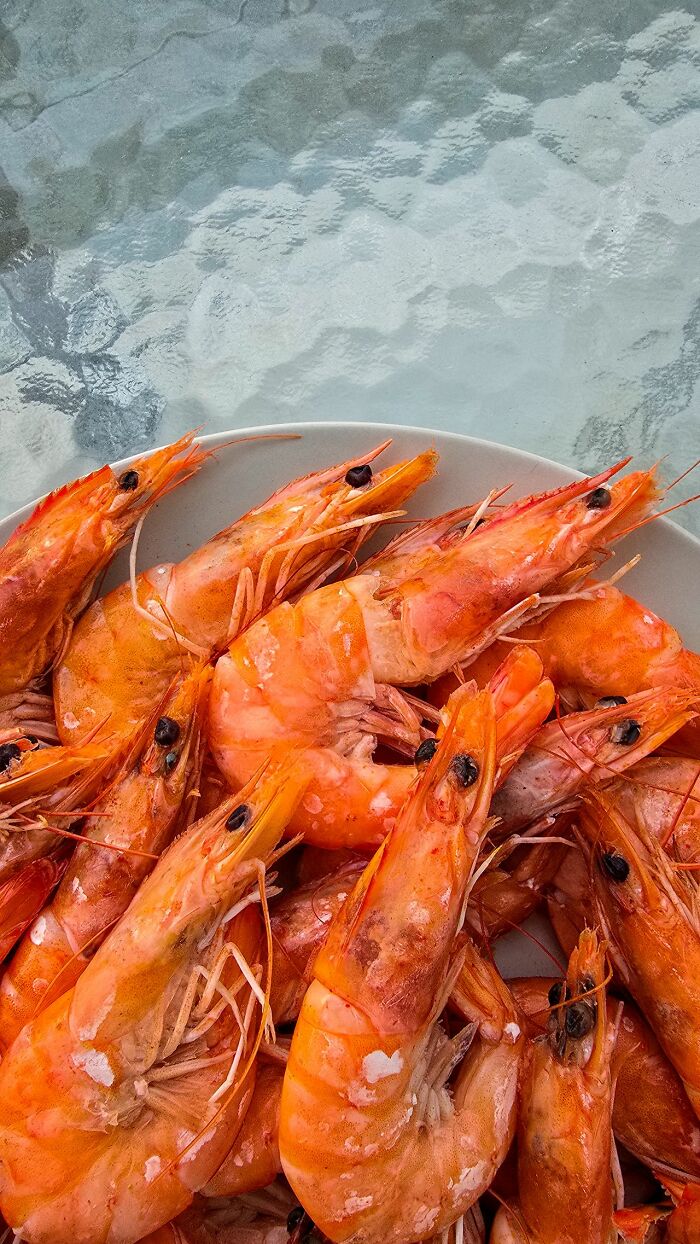 A close-up of cooked shrimp on a plate, unrelated to savage things people did after relationships fell apart.