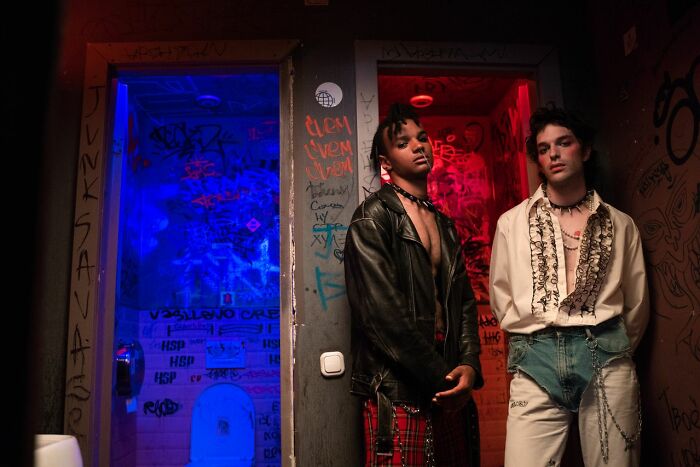 Two young men in an edgy setting, reflecting the savage things people did after their relationships fell apart.