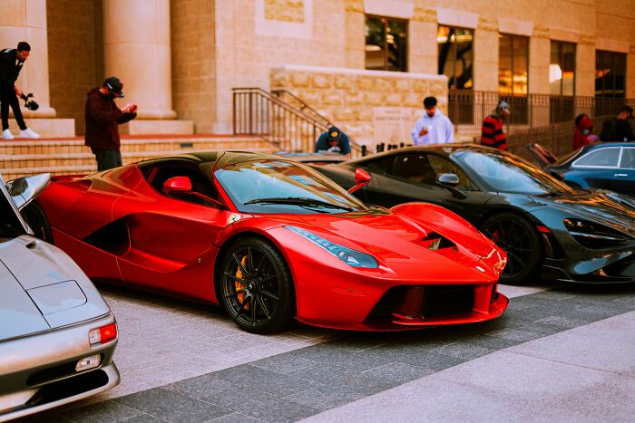 Luxury sports cars parked, highlighting the varied paths a life story can take to an unexpected end.