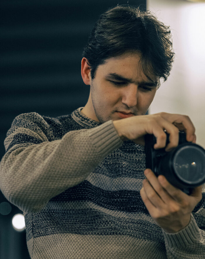 Man adjusting camera on vacation for perfect shot