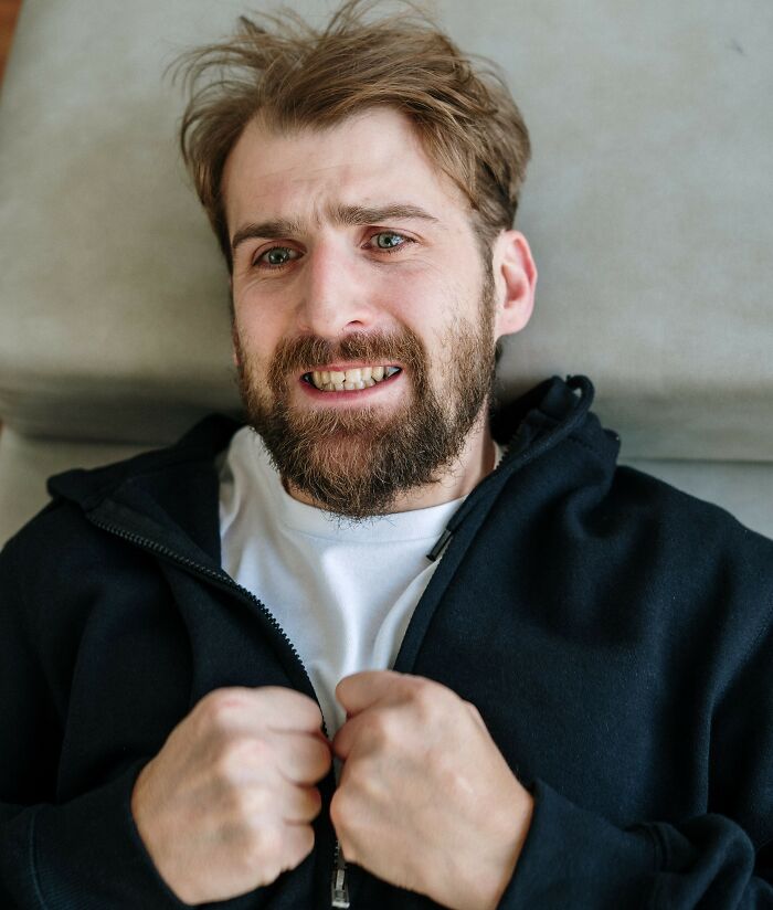 A man with a beard and distressed expression, showing signs of being a sociopath.
