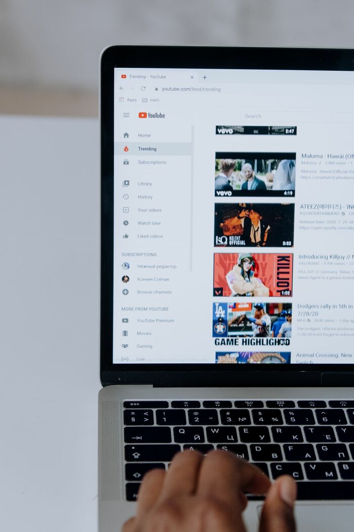 A laptop displaying YouTube trending videos, illustrating how mainstream platforms affect simple joys.