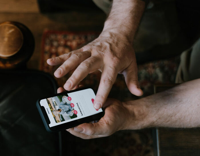 A man's hands scroll through dating profiles on a smartphone, part of his Becky experiment to test different dating profiles. A man's hands scroll through dating profiles on a smartphone, part of his Becky experiment to test different dating profiles.