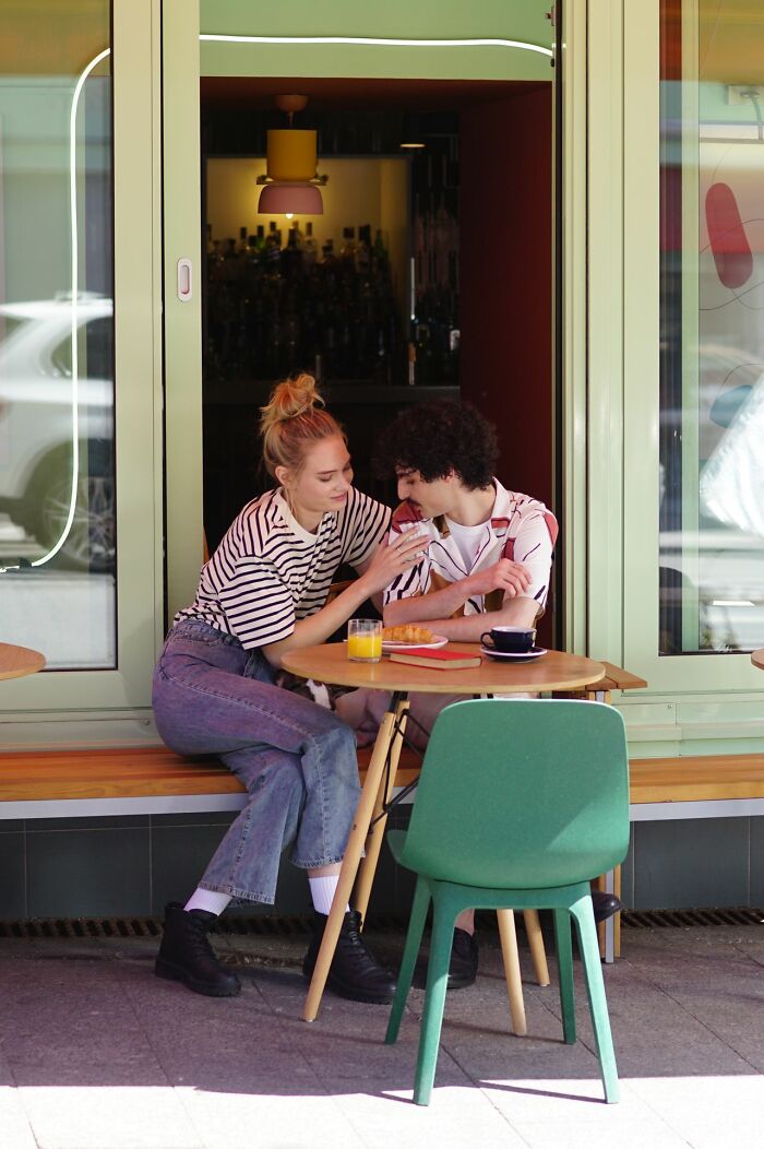 Couple enjoys a delicious dinner outside a restaurant, with hot tea likely available at a table nearby.