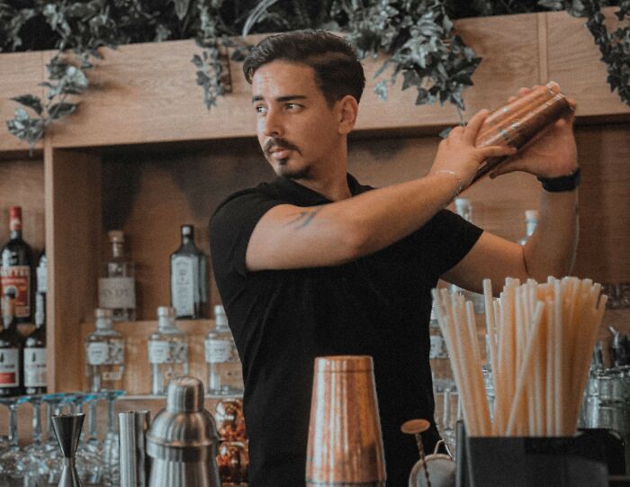 Bartender shaking cocktail in restaurant bar