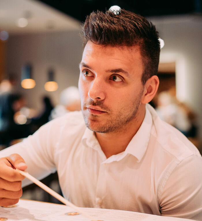 A man looks contemplative, potentially reflecting on lies men told.