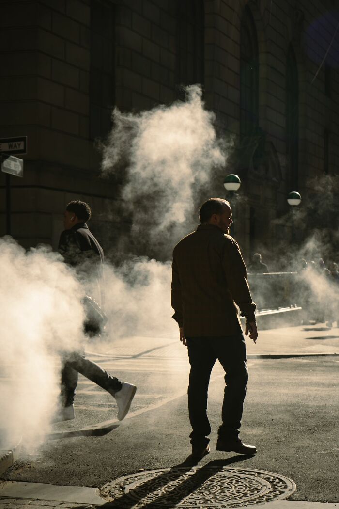 Steam rising from a manhole on a city street, a stereotype about the US.