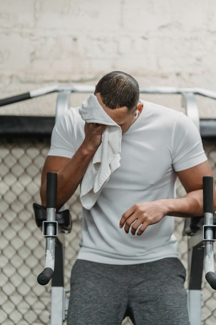 A man wiping sweat from his face at the gym, representing simple joys ruined by becoming mainstream.