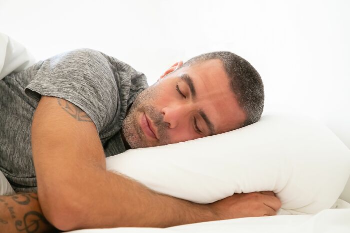 Man sleeping peacefully on bed