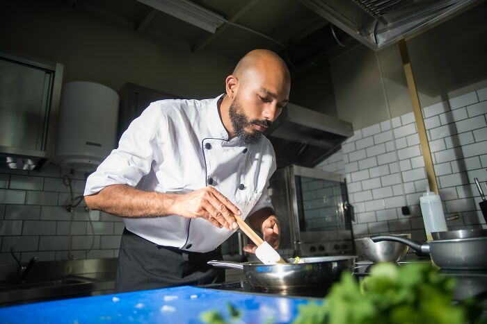 Restaurant chef preparing food focused in the kitchen