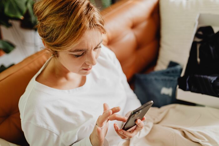 A parent looking at her phone, realizing what her children were going through.