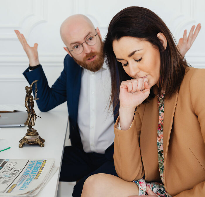 A distressed woman with a therapist or lawyer, discussing a sociopath in a professional setting.