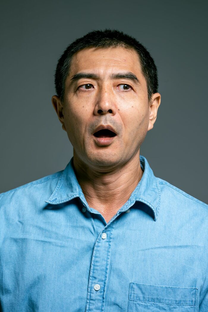 Man with an open mouth, looking surprised by delicious dinner and hot tea.