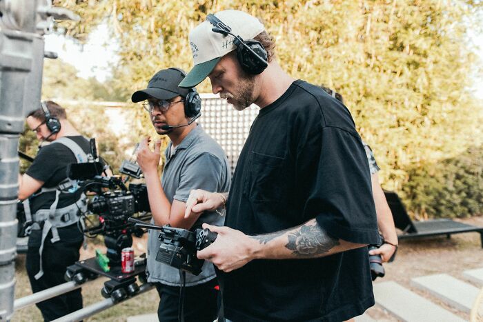 Two professionals on a film set reviewing footage, showcasing industry secrets in film production.