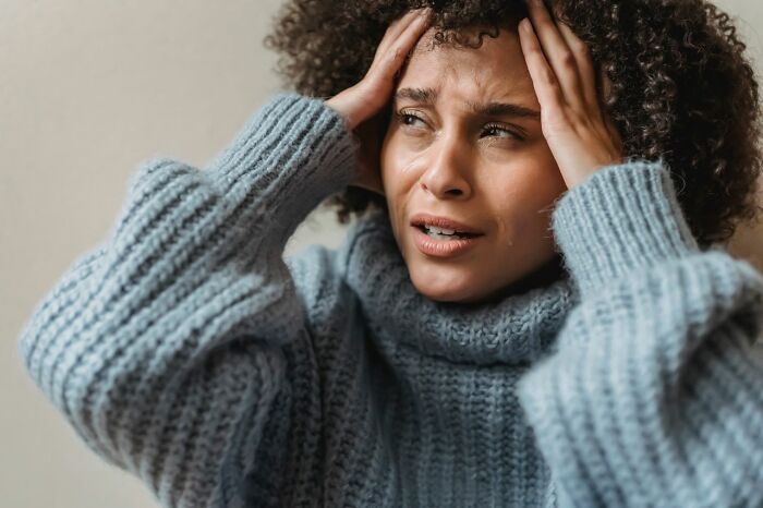 A person looking distressed, possibly after being served a delicious dinner or hot tea, with a tear on their cheek.