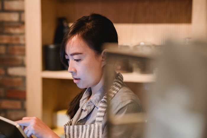 Barista using tablet in cozy restaurant setting