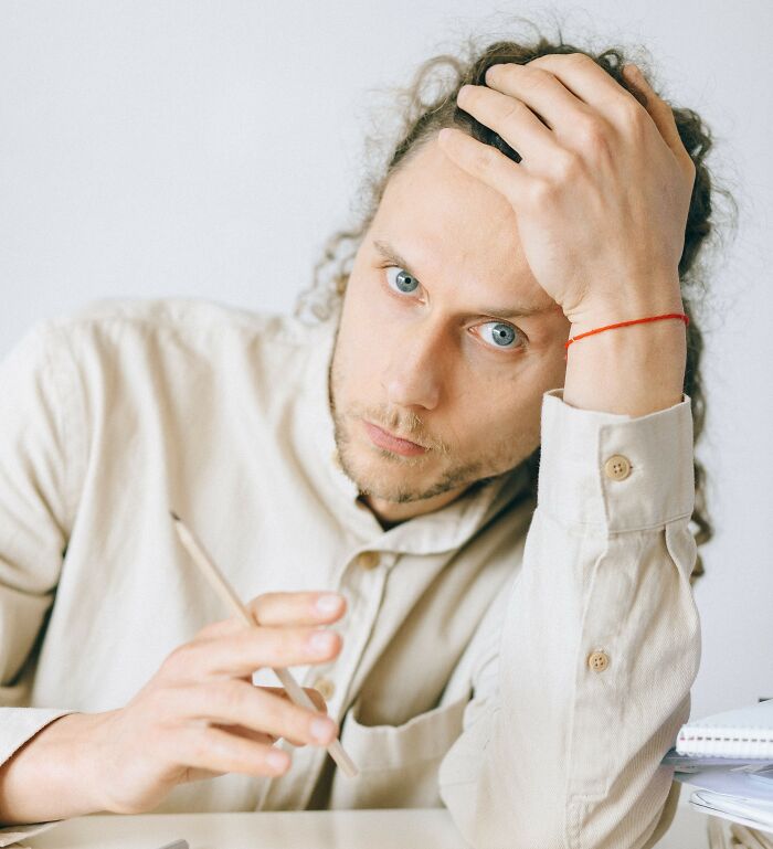 A man with curly hair and intense blue eyes, representing a sociopath observed by therapists.