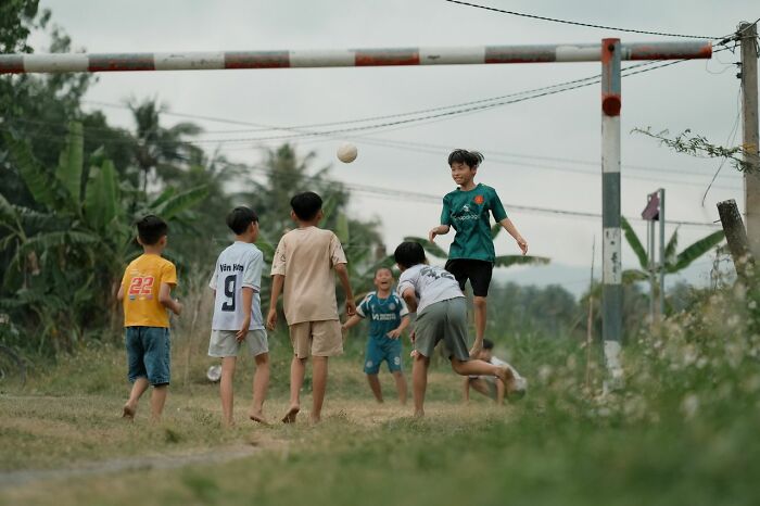 Boys playing soccer outdoors, a simple joy that has been ruined after becoming mainstream.