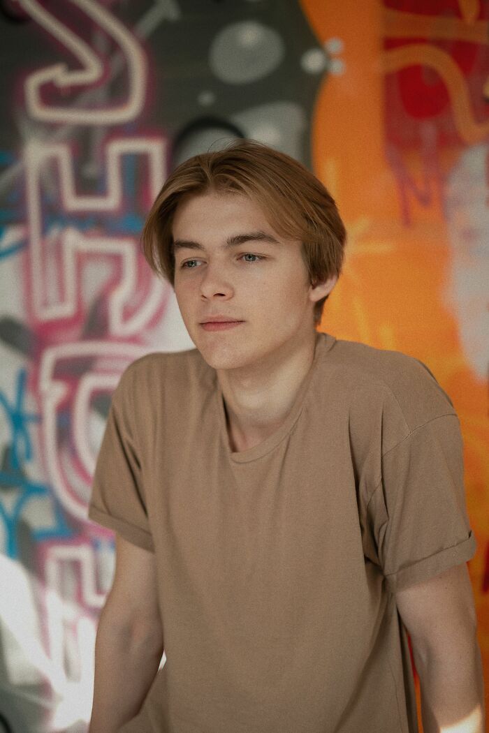 A young man looking away, representing dating red flags and questionable dating experiences.
