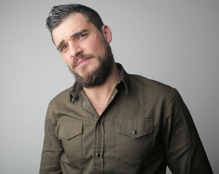 A man with a beard looking confused or guilty, symbolizing the lies men told them that were unhinged.