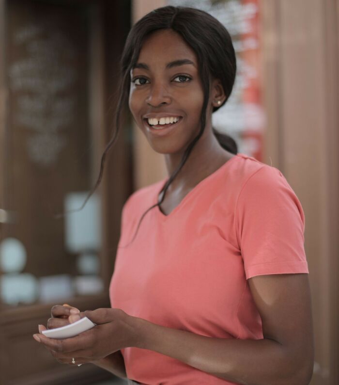 Smiling restaurant hostess taking order with pad