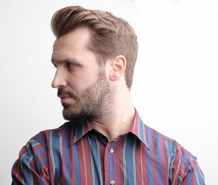 A man looking away thoughtfully, perhaps reflecting on the lies men told them.
