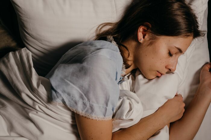 Woman peacefully sleeping with pillow during vacation rest