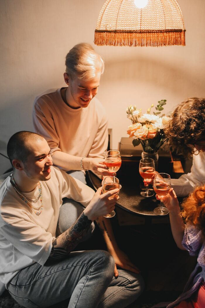 Friends toasting with drinks, capturing a moment people overheard.