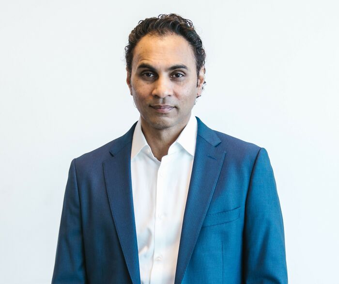 A male therapist in a blue suit and white shirt, looking directly at the camera, sharing insights on sociopaths.
