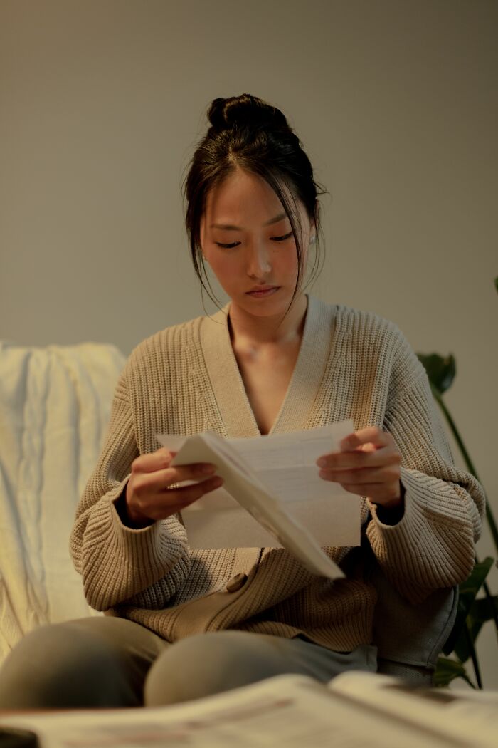 Woman reading a letter, representing parents understanding what their children were going through.