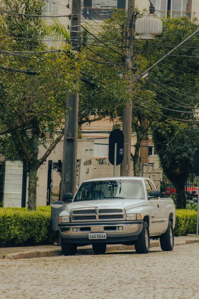A white truck parked on a street, illustrating awareness of surroundings for women's safety tips.