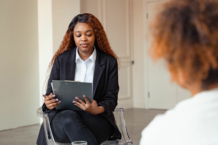 A therapist reviews notes, assessing if a patient displays signs of a sociopath, focusing on diagnostic criteria.