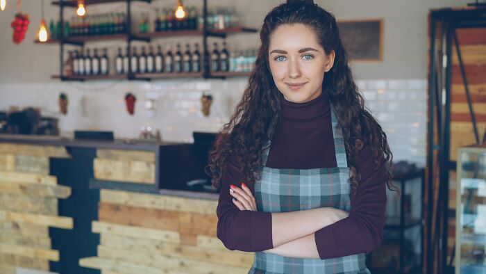 Confident restaurant owner standing with arms crossed
