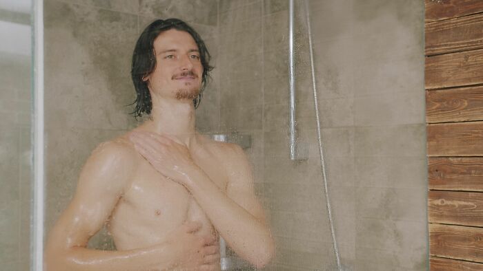 A man showering, showing a dating red flag.