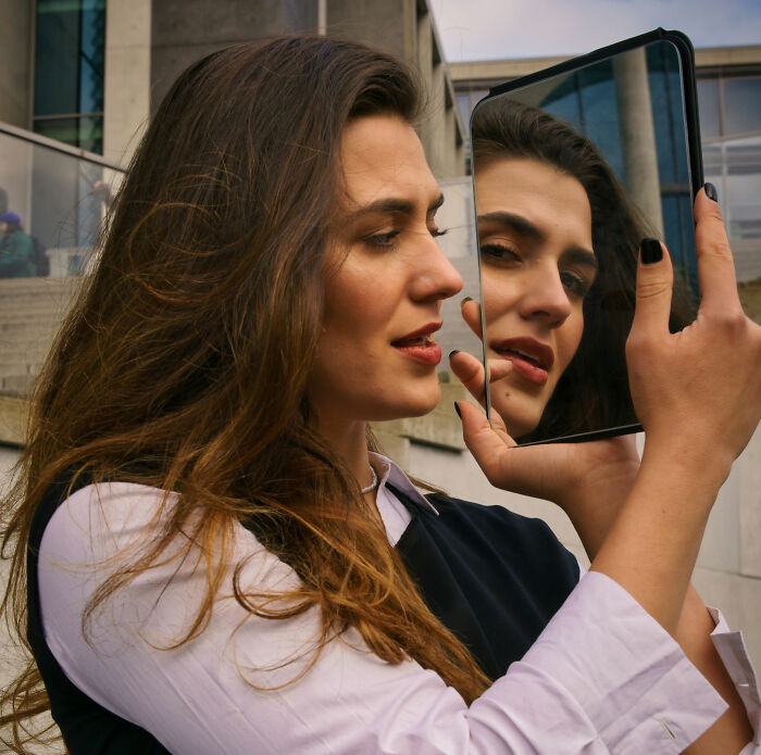 A woman looking into a mirror, part of the dating profiles Becky Experiment to test results. A woman looking into a mirror, part of the dating profiles Becky Experiment to test results.