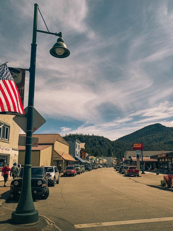 A street scene in a small American town with an American flag, embodying a US stereotype.