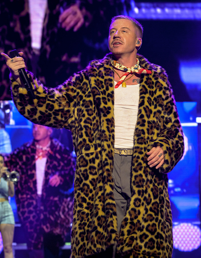 Pink addresses criticism, losing fan support. A performer in a leopard print coat holds a microphone. Pink addresses criticism, losing fan support. A performer in a leopard print coat holds a microphone.