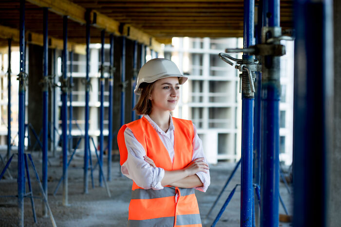 A female engineer in a hard hat and safety vest, highlighting women in male-dominated fields facing subtle sexism.