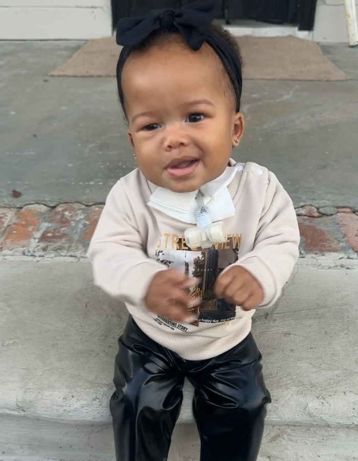 An adorable young baby girl sitting on steps, representing the miracle baby. An adorable young baby girl sitting on steps, representing the miracle baby.