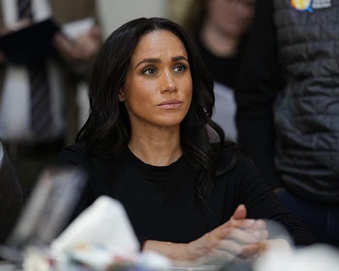 Meghan Markle looking thoughtful at an event