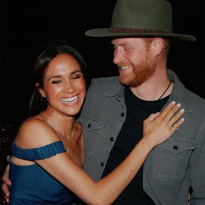 Prince Harry and Meghan Markle smiling and embracing warmly