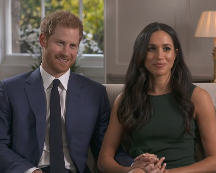 Prince Harry and Meghan Markle seated together in a formal interview setting